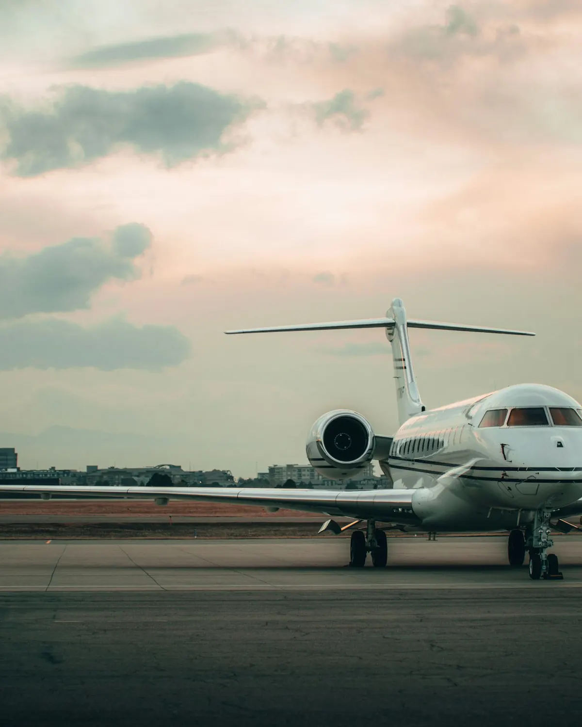 Business jet waiting on the ramp at dusk