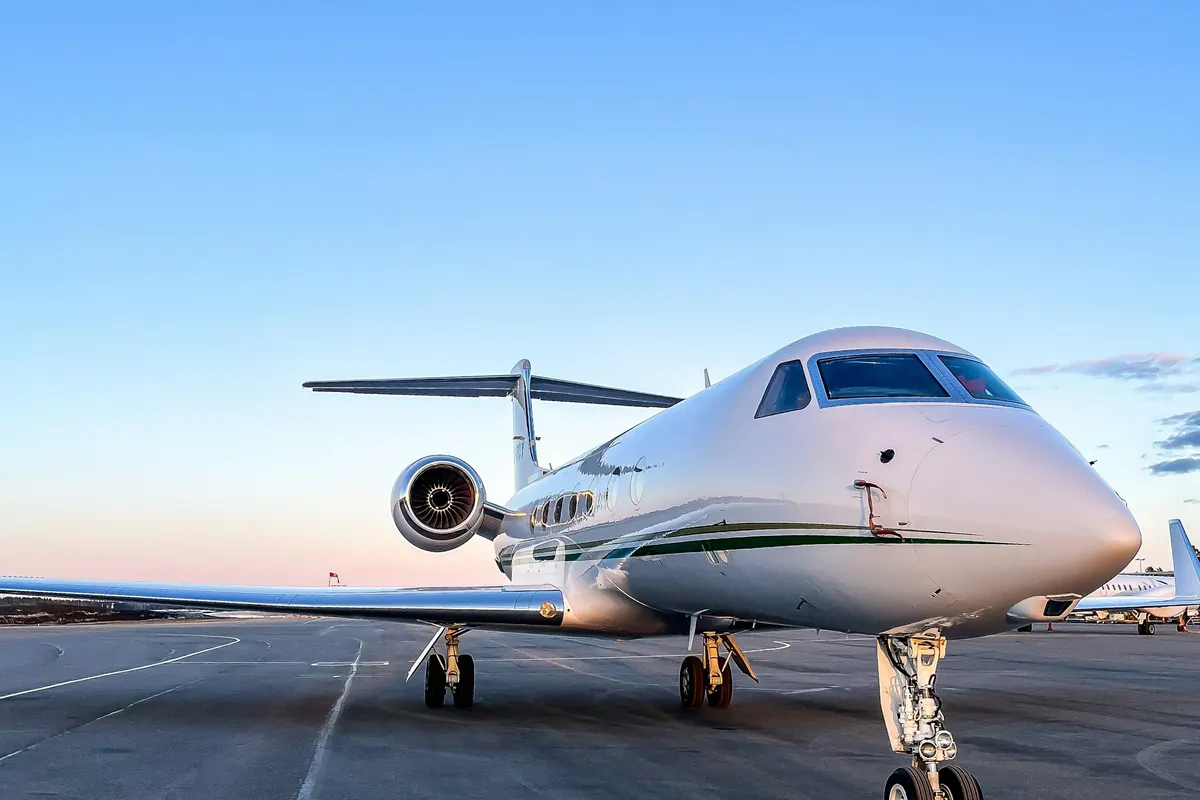 Nose of a business jet on a sunny ramp, seen head-on