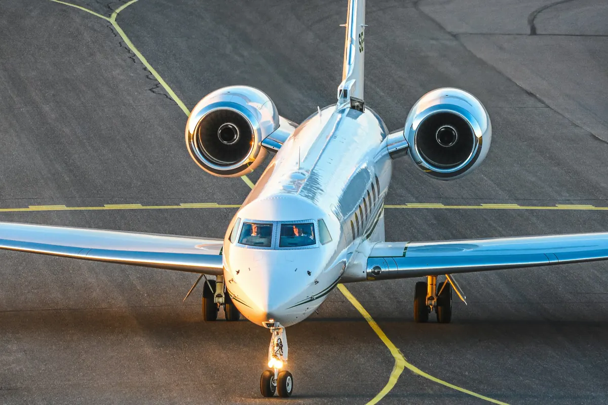 Business jet taxiing toward the camera at dusk